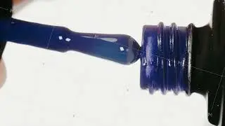 Blue gel nail polish on a white background. Media. Extreme closeup.