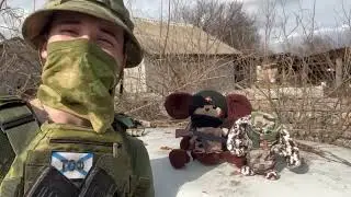 Russian Sniper finds time to play with a teddy bear.