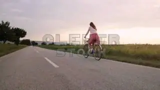 Young Woman Riding Bicycle Summer Dress Field Sunset - Stock Footage