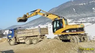 CAT M313C excavator loading TATRA truck with gravel