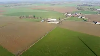 Aerial view of windmills and agricultural fields in 4K  | Free Stock Video