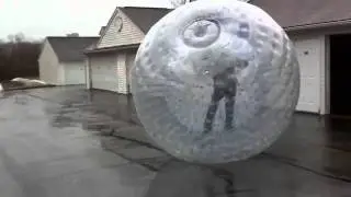 Adam rolling around in zorb like human hamster ball