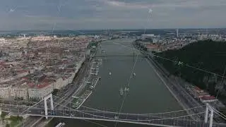 Aerial view of Danube river and its bridges in Hungarian metropolis. Ships moored along waterfront