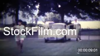 1971: Family arrives in Volkswagen Beetle Bug car parks on lawn. DES MOINES, IOWA