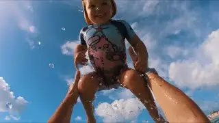 Naomi is swimming on her back for first time in the Ocean at Miami Beach