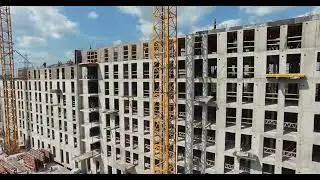 flying along the apartment complex under construction unfinished concrete building
