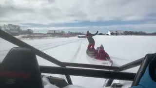 man pulling family in canoe on snow - 1324841