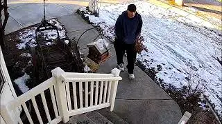 Thief caught on security camera stealing christmas parcel from front door