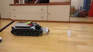 General purpose remote controlled mobile robot picks up several objects and seems to be happy.