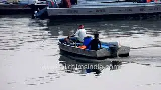 Daily life on the Yamuna: Passengers are carried through Delhi's waters by a motorboat