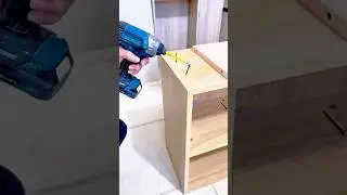 Assembling a Wooden Shelf Cabinet by Drilling and Securing Each Panel with Precision Screws