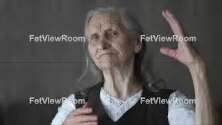 Close-up face of old woman with deep wrinkles stroking grey hair