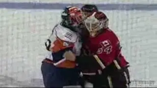Kyle Okposo gets hammered by Dion Phaneuf