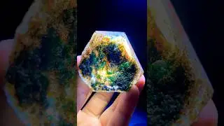 Raw phantom quartz specimen with green and rust-colored inclusions, creating an inner landscape
