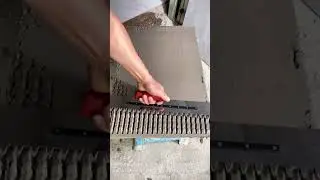 The process of grooving tile adhesive for perfect tile laying