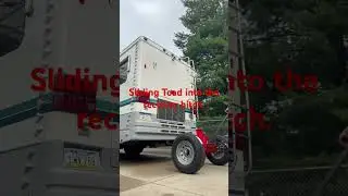 Sliding the Trailer Toad shank into the receiver hitch opening.