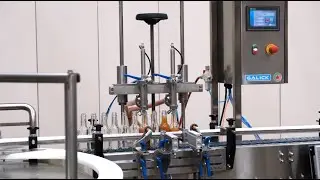 Hot Sauce Packaging Line. Filler, Capper, Labeler, Neck Bander and Heat Tunnel