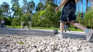 Group of school kids performs sports motivational greeting with hands on playground of yard football