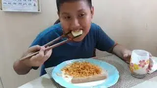Eating buldak carbonara noodles with sausages and cucumber with lassi
