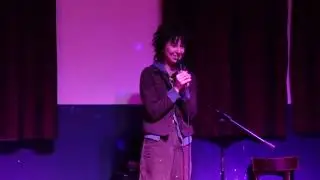 joan doing stand up comedy in a bar in bushwick