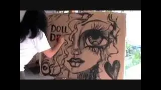Painting a dollie on cardboard.