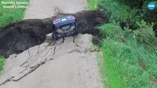 Car crashed into hole after township road washed out around the culvert beneath