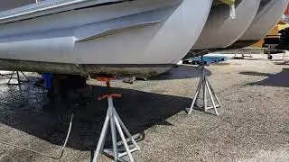 Pressure cleaning a pontoon hull.