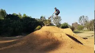 Guy black shirt bikes dirt hill fall