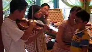A Chinese host brother playing Violin