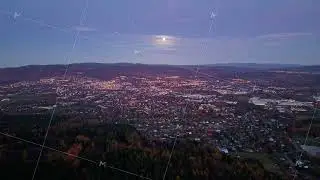 nighttime cityscape panorama, serene evening scene highlighting distant hills and illuminated