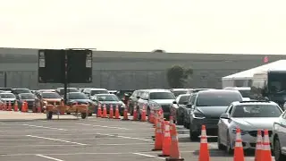 Cars line up at Miami's Hard Rock Stadium testing site as Covid-19 cases rise | AFP