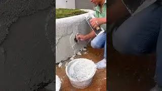 Applying textured white cement plaster on outdoor wall surface