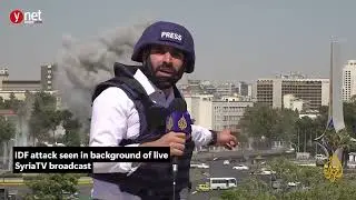 IDF attack seen in background of live SyriaTV broadcast Ynet Global