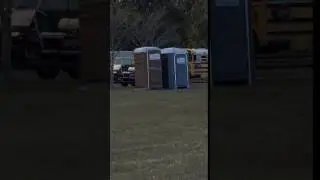 Guy in Stilts Comes Out of Portable Restroom