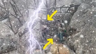 Extreme Winter Survival Shelter Between Two Rocks in a Snowstorm