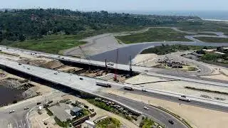 Aerial view of bridge construction crossing the highway in California | Free Stock Video