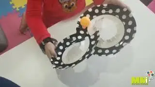 Move a ping-pong ball across the midline on a paper-plate maze
