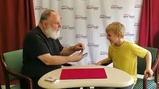 Basil showing one of our junior magicians a Wild Bill Hickok trick.