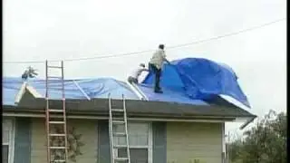 Vounteers Help Tack Down Blue Tarps