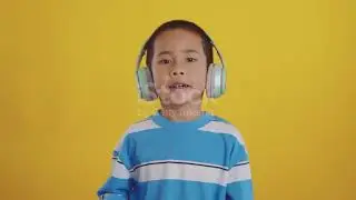 Boy listening dancing on yellow background. 4K stock video