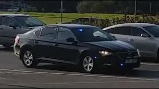 Unmarked Police car responding in heavy traffic