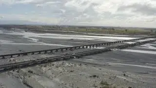 Vehicles driving over Rakaia Bridge, South Island New Zealand