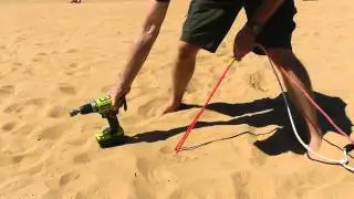Large plastic Peggy Peg screwed into soft sand