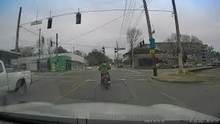 Infuriating scooter girl texts through entirety of traffic light, then decides to run it