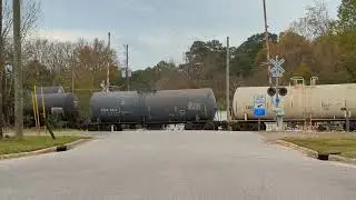 Conductor flagging a crossing with the gates up for a CSX train in Raleigh, NC (2022-11-15)