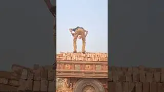 How is the man loading bricks into the tractor truck?