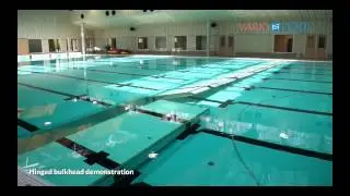 Hinged bulkhead swimming pool