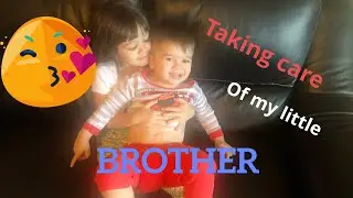 Sister taking care of  BABY brother