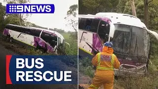 Passengers rescued after bus slips down embankment | 9 News Australia