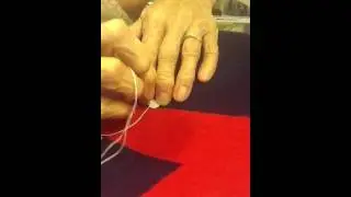 Sew on button on button blanket, front in first, no knot